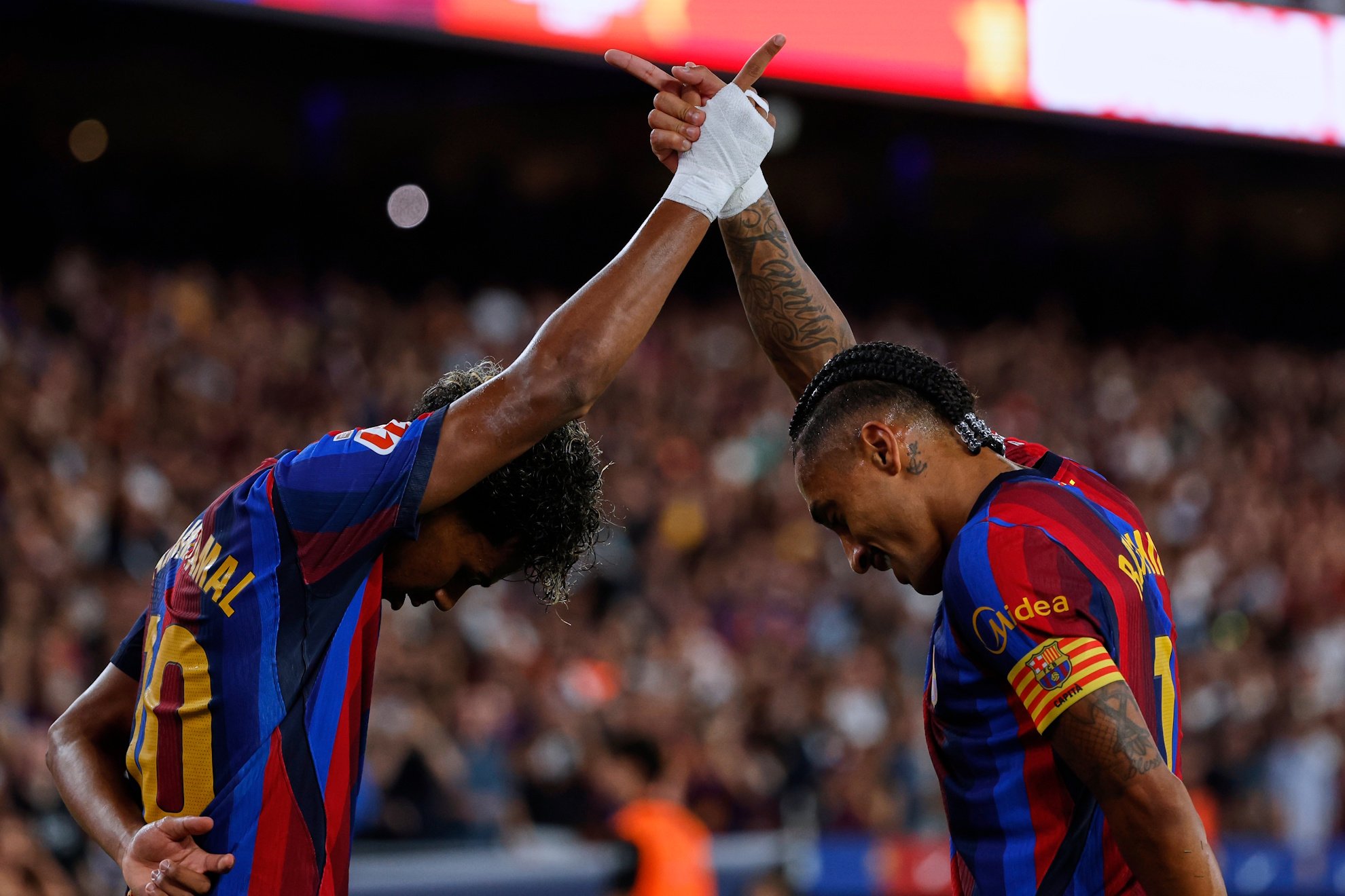 Raphinha and Lamine Yamal celebrating together for Barcelona