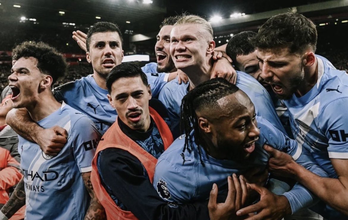 Manchester City players celebrate their 3-0 Premier League victory over Liverpool at Anfield.